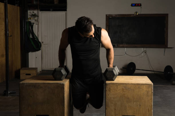 istock Man working on his arms in a gym 692027010