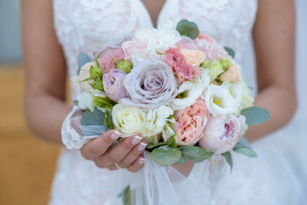 istock Beautiful bride is holding a wedding colorful bouquet 692040958
