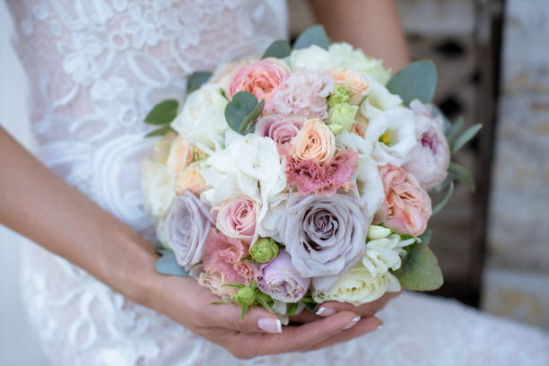 istock Beautiful bride is holding a wedding colorful bouquet 692051528