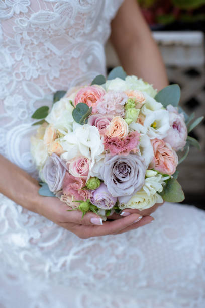 istock Beautiful bride is holding a wedding colorful bouquet 692051546