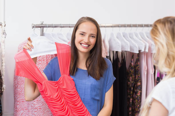 istock Happy brunette showing a red dress 692052808