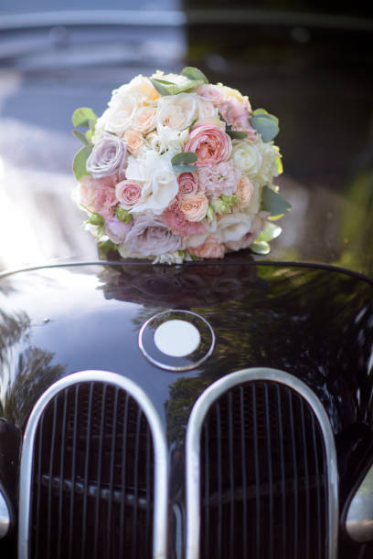 istock Beautiful wedding colorful bouquet and car for bride 692052912