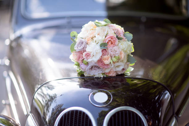 istock Beautiful wedding colorful bouquet and car for bride 692052938