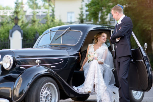 istock Wedding couple is hugging each other near a car 692055440