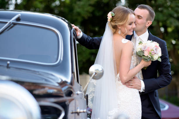 istock Wedding couple is hugging each other near a car 692055554