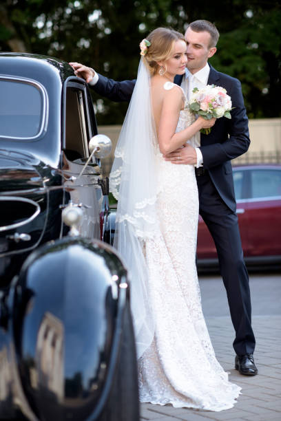 istock Wedding couple is hugging each other near a car 692055614