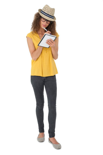 istock Serious cool young woman writing in notepad 692055644
