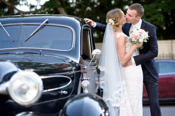 istock Wedding couple is hugging each other near a car 692055670