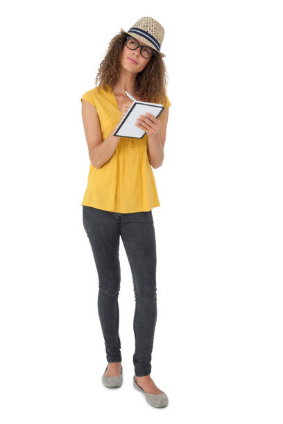 istock Thoughtful cool young woman writing in notepad 692055672