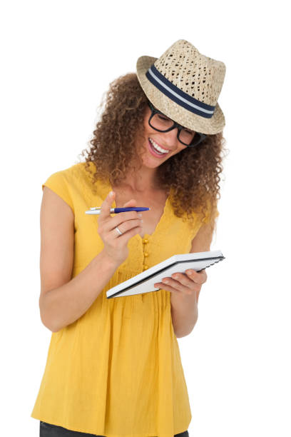 istock Cheerful young woman writing in notepad 692055706