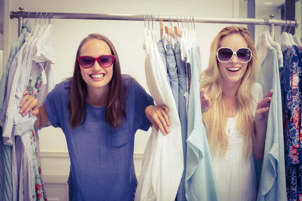 istock Happy friends looking through the clothes rack 692055784