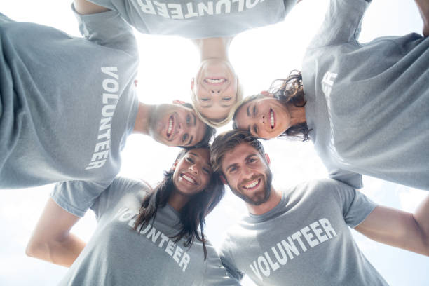 istock Happy volunteers forming huddle 692064276