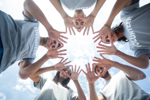 istock Happy volunteers playing with their hands 692064502