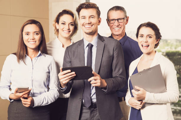istock Smiling Business Team Standing in Conference Room 692067746