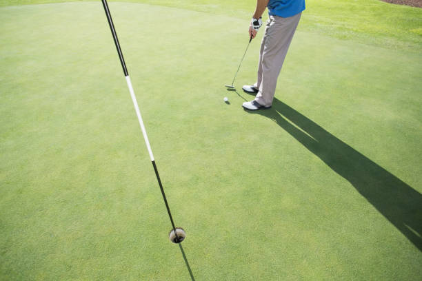 istock Golfer putting ball on the green 692077674