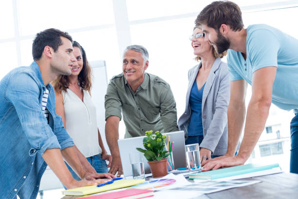 istock Casual colleagues using laptop in the office 692087222