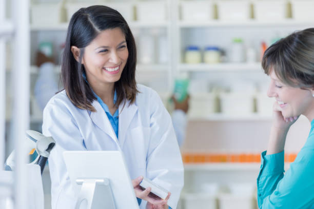 istock Smiling female pharmacist helps customer 692088014