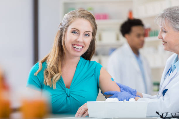 istock Young woman receives flu shot 692088086