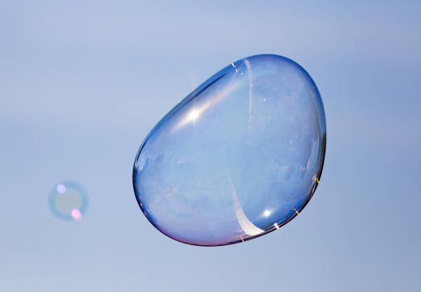 istock Big soap bubble against the blue sky 692091166