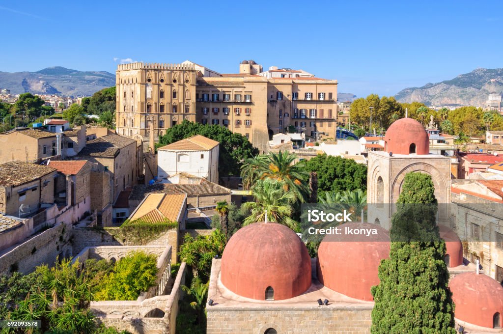 View from San Giovanni degli Eremiti - Palermo The famous red domes of the Church of St. John of the Hermits (San Giovanni degli Eremiti) and the Norman Palace (Palazzo dei Normanni) - Palermo, Sicily, Italy Palazzo Dei Normanni Stock Photo