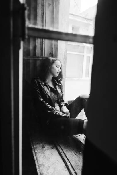 istock beautiful woman poses on a window sill 692099460