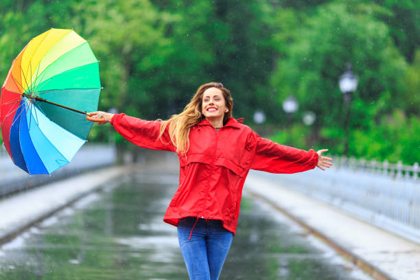 istock Cheerful young woman enjoying the rain 692102898