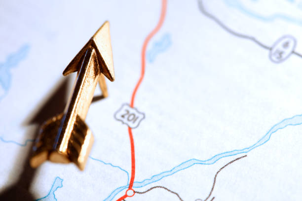 istock Gold Arrow Pointing The Way On Road Map 692106224
