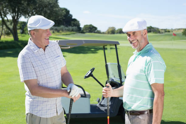 istock Golfing friends chatting beside their buggy 692106476