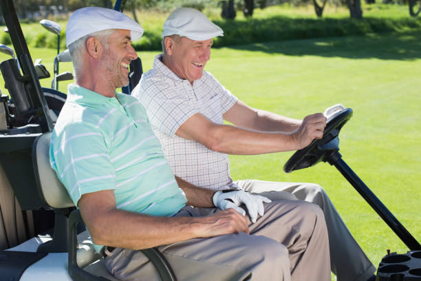 istock Golfing friends laughing together in their golf buggy 692106760