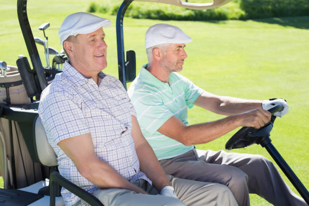 istock Golfing friends driving in their golf buggy 692108888