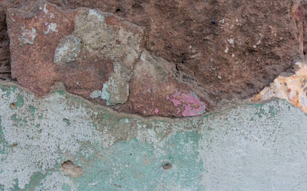 istock Old painted wall. Green and pink damage surface. Peeling paint background. Stone demaged backdrop. 692109938