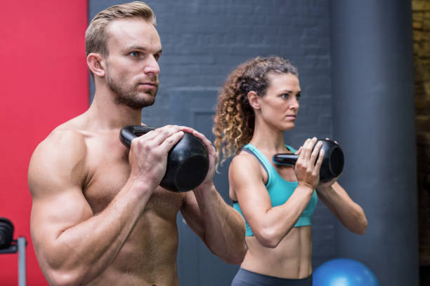 istock Muscular couple exercising with kettlebells 692122204