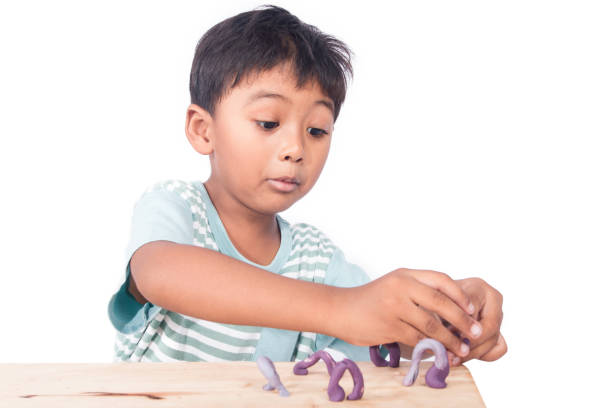istock cute asian little boy play clay 692122244