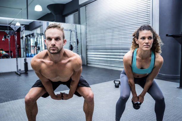 istock A muscular couple lifting kettlebells 692122700