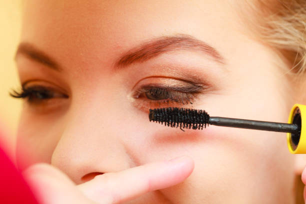 istock Close up woman getting make up, mascara 692125818