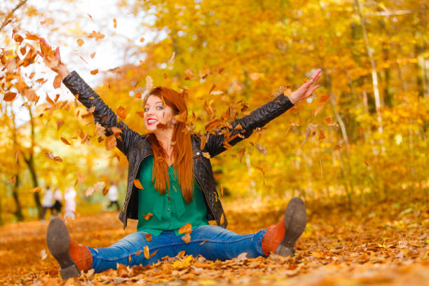 istock Crazy girl throwing leaves. 692129230