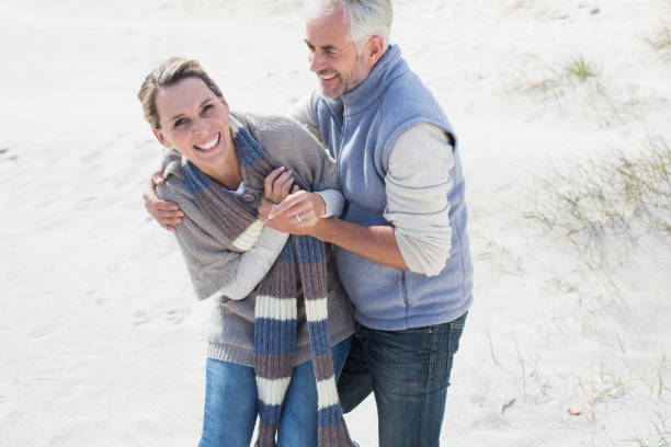 istock Attractive couple messing about on the beach 692132146