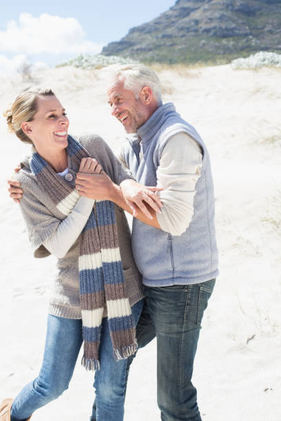 istock Attractive couple messing about on the beach 692132322