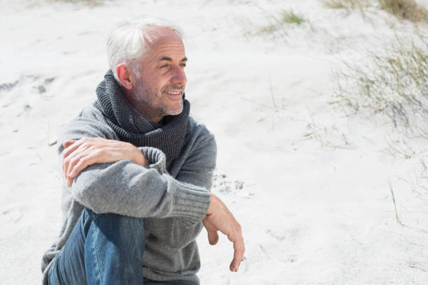 Attractive man smiling on the beach in scarf