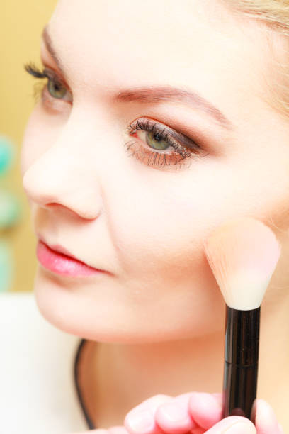 istock Close up woman getting make up, blush 692136784
