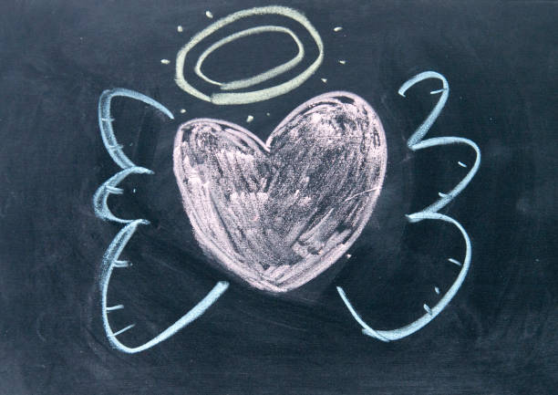 istock heart angel sign drawn with chalk on blackboard 692141694