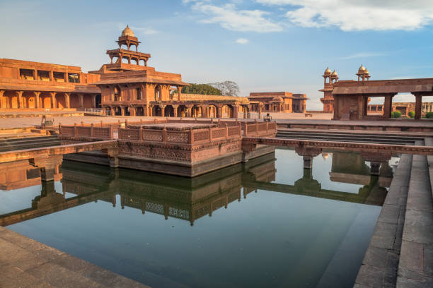 istock Fatehpur Sikri Anup Talao - a classic red sandstone architectural structure with a pool connected with four bridges used for Medieval concerts. 692142248