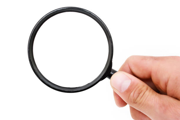 istock Man's hand with magnifying glass. 692146260