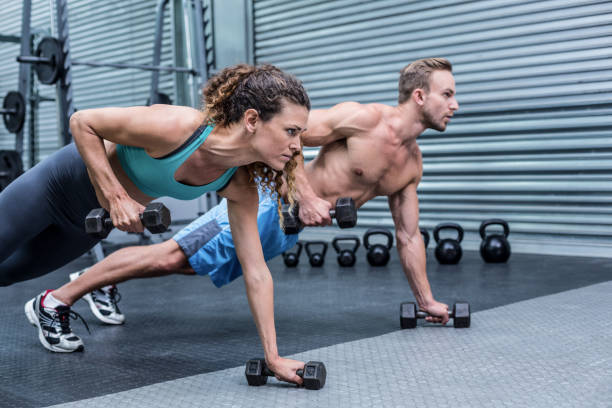 istock Muscular couple doing plank exercise together 692146722