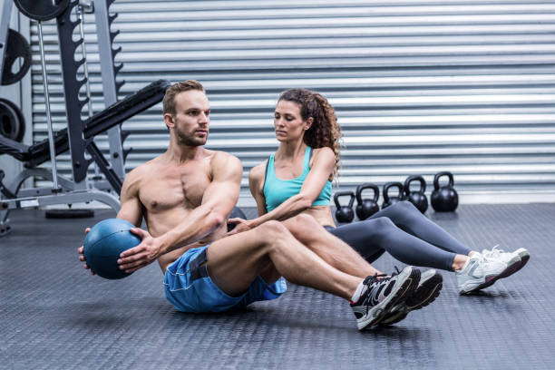 istock Muscular couple doing abdominal ball exercise 692147206