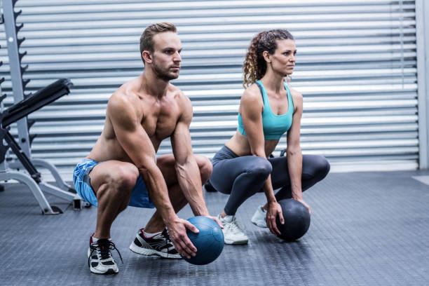 istock Muscular couple doing ball exercise 692147250