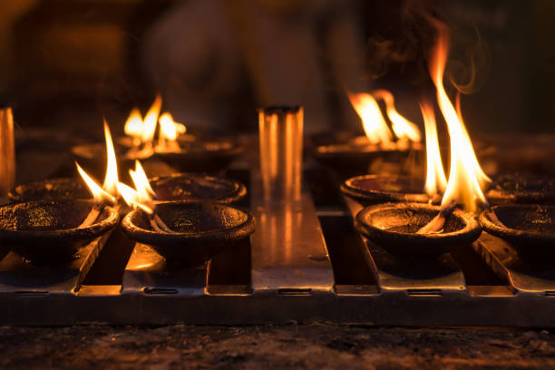 istock Burning candles in Buddhist temple at night 692147610