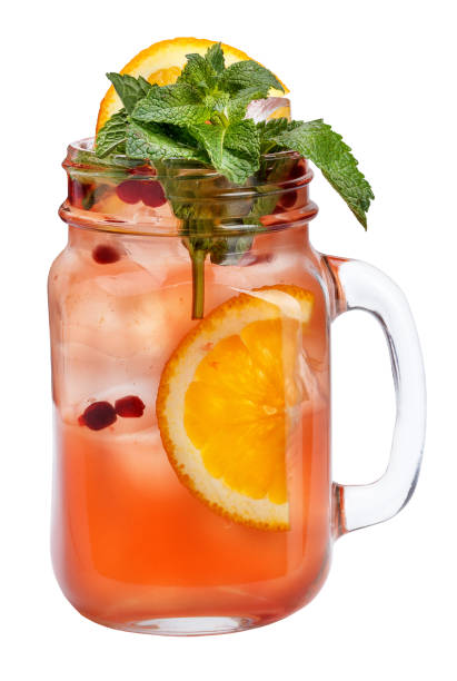 istock Fresh refreshing drink with ice cubes in Mason jars with orange, cranberries and mint. Summer drink on white background. 692153812