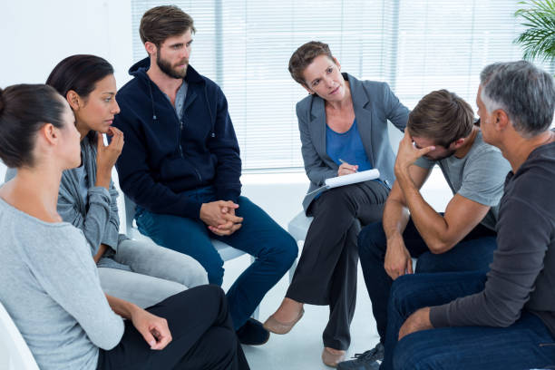 istock Concerned woman comforting another in rehab group 692153858