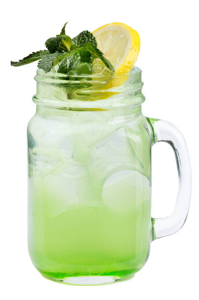 istock Fresh refreshing drink with ice cubes in Mason jars with lemon and mint. Summer drink on white background. 692154032